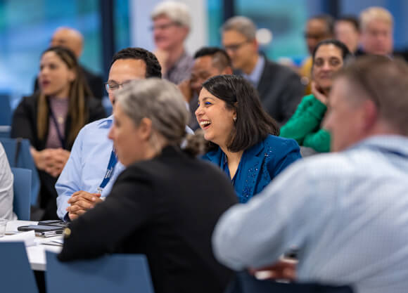 Several members of the medicine faculty smile and laugh together during a celebration